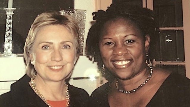 Debbie with Hillary Rodham Clinton: Multimedia Producer Deborah Mitchell smiling and standing next to Hillary Rodham Clinton